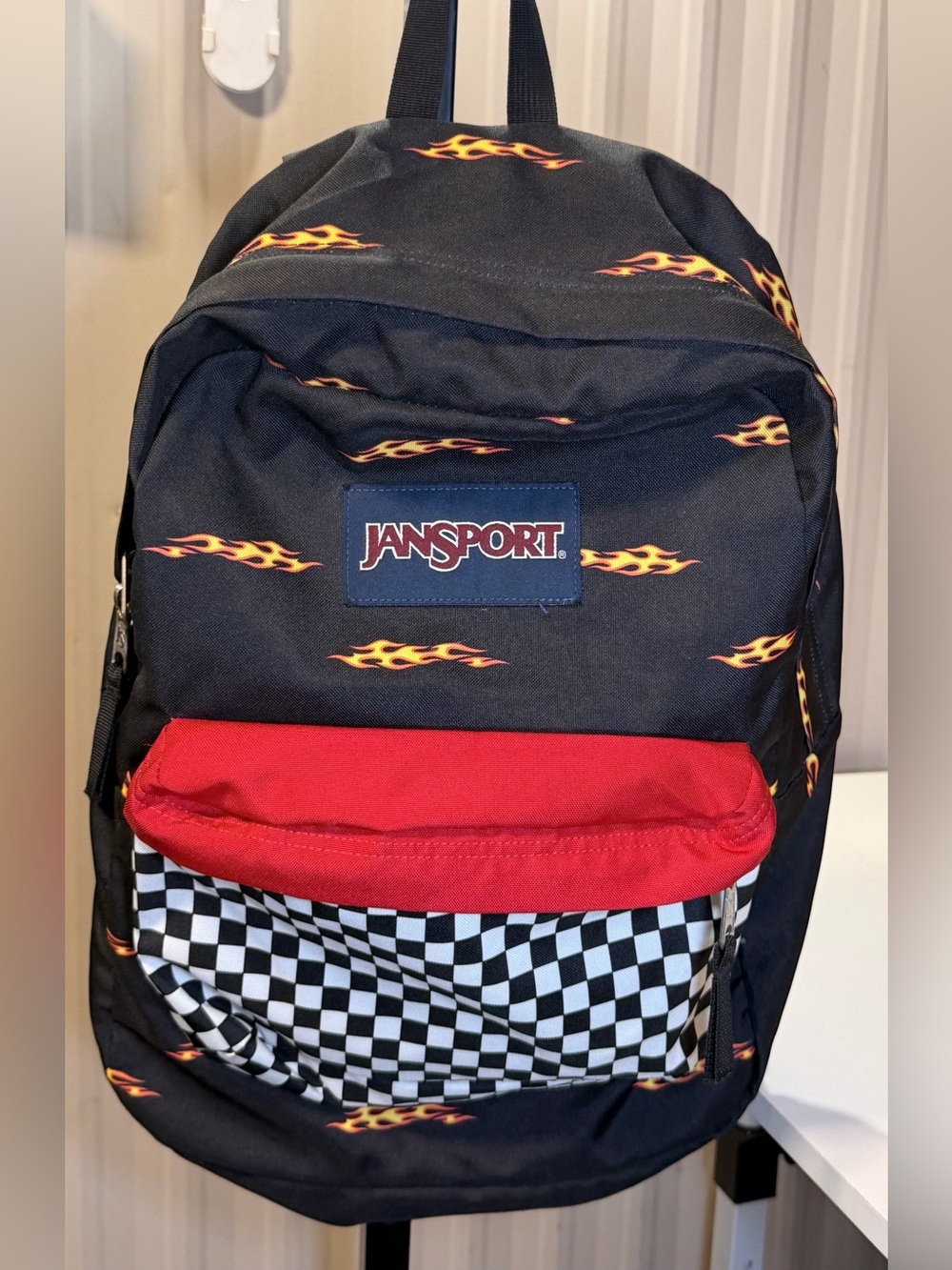 Jansport Black Backpack with Red Pocket and Flame Accents